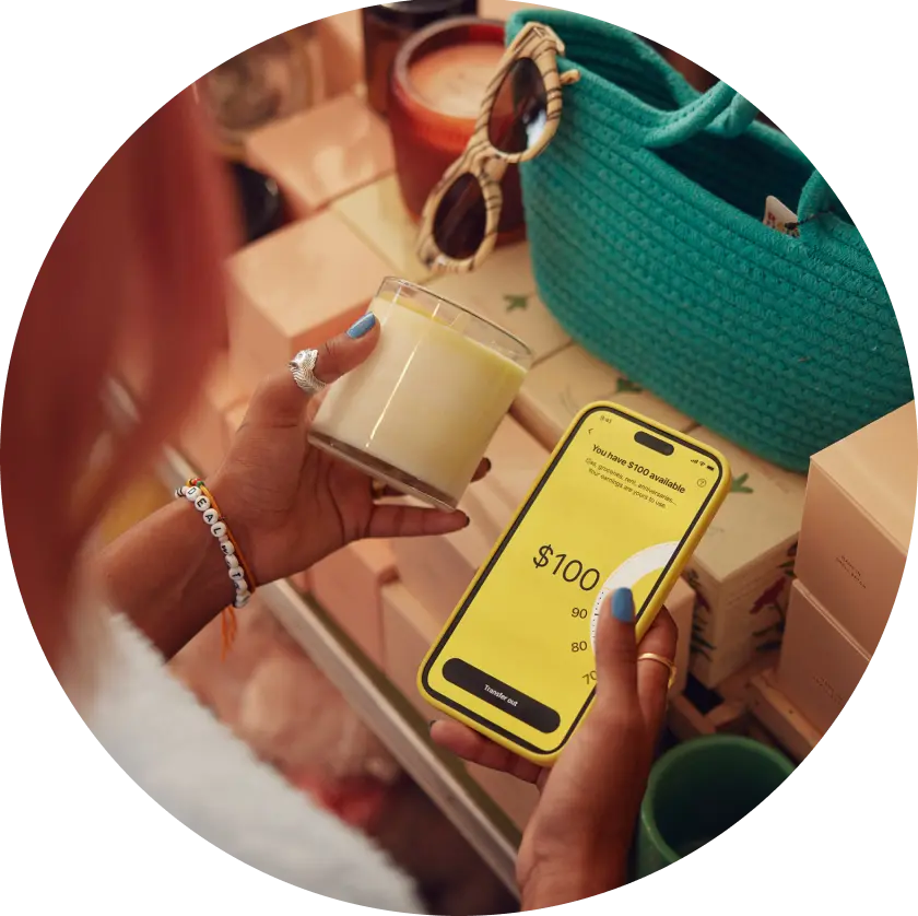 image of a user opening EarnIn application on a mobile phone while considering to buy an item